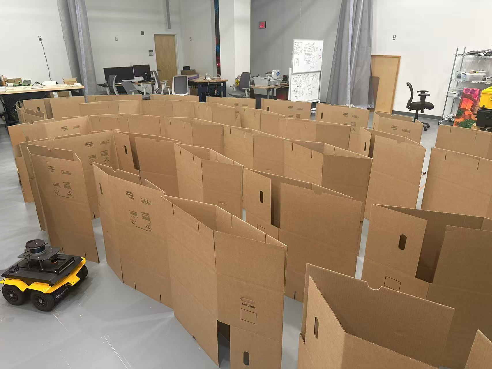 Cardboard obstacle course with narrow passages and a wheeled robot