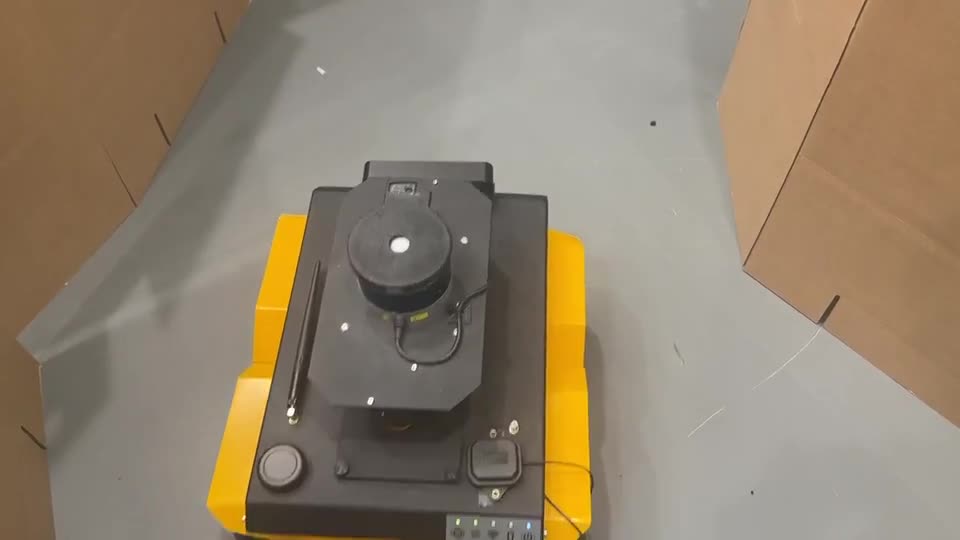 Wheeled robot navigating narrow passages between cardboard obstacles